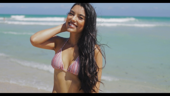 Content Model in Bikini Standing on Beach