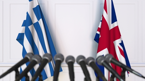 Flags of Greece and The United Kingdom at International Press Conference alt