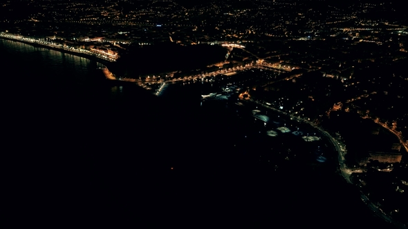 Night Aerial View of Illuminated Nice Town in France. Flight Over Nice Marine Port.