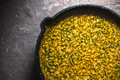 Yellow curry paste in a cast-iron frying pan closeup. Indian food - PhotoDune Item for Sale