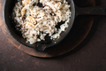 Fried onions, garlic and mustard seeds in a cast-iron frying pan. Indian food - PhotoDune Item for Sale