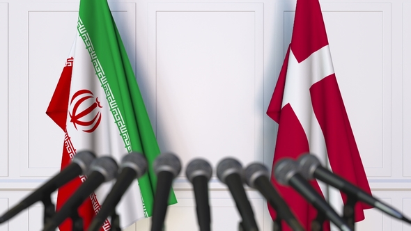 Flags of Iran and Denmark at International Press Conference alt