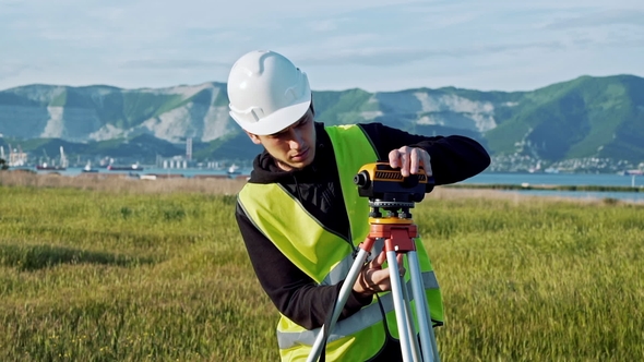 Surveyor Engineer Is Measuring Level on Construction Site