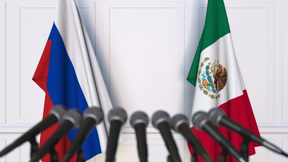 Flags of Russia and Mexico at International Press Conference alt