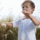 Funny Little Boy in a White Shirt Stands in the Middle of the High-grass, Speaks To Someone and - VideoHive Item for Sale