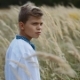Joyful Boy in a Traditional Ukrainian Embroidered Shirt Standing in the Middle of Field of Wheat - VideoHive Item for Sale