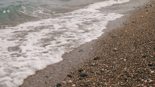 Seashore, Surf on a Pebble Beach, Clear Water, Cloudy Weather