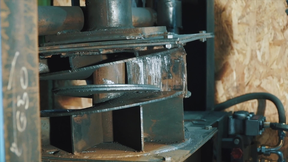 Molding of Parts of Wheels By Press in Automobile Factory. Clip. Worker Is Commanding Tool and