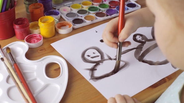 Young Sad Girl Draws People with Black Paints