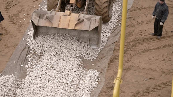 Builders Using Yellow Bulldozer on a Construction Site