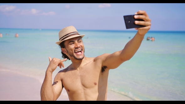Man Gesturing Shaka and Taking Selfie