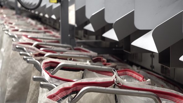 Staff Working at the Automated Parcel Sorting System Filling Bags