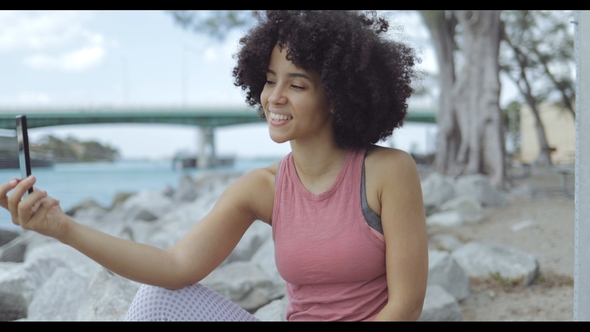 Cheerful Black Woman Taking Selfie on Seafront