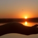 Hands Holding Sun in Palms in Beautiful Sunset over Water - VideoHive Item for Sale