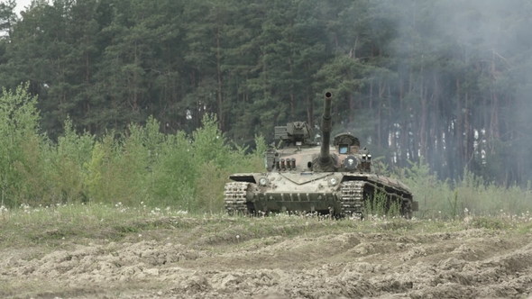 Military Tank In Movement On A Dirt Ground Terrain