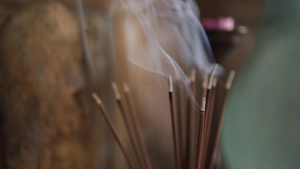 Incense Sticks Burning and Making Beautiful Smoke on the Table in Yoga Practice Room