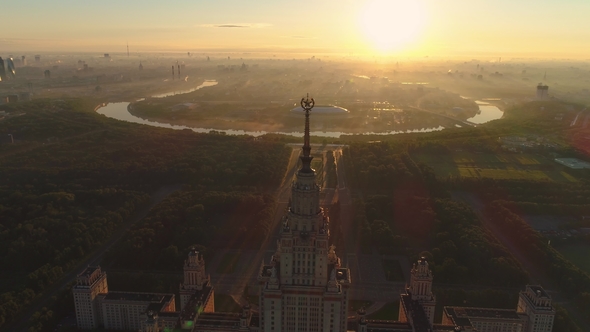 Moscow State University in the Sunny Morning and City in Sunrise Fog