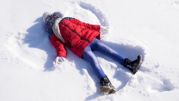 Girl Makes Snow Angel.