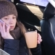 Young Beautiful Girl Is Sitting in Front Seat of Car and Talking on Phone - VideoHive Item for Sale