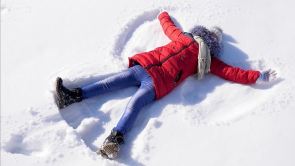 Happy Child Makes Snow Angel