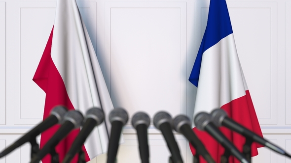 Flags of Poland and France at International Press Conference alt