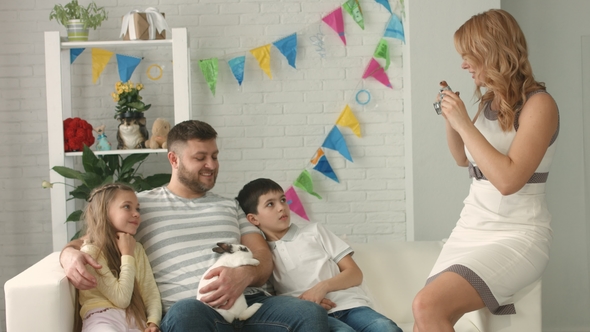 Mom Takes Pictures of Her Family with the Easter Bunny on the Camera at Home