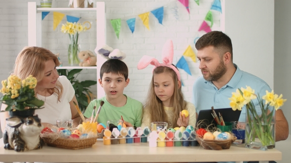 Happy Family with Children Talking on Skype with Relatives for Easter