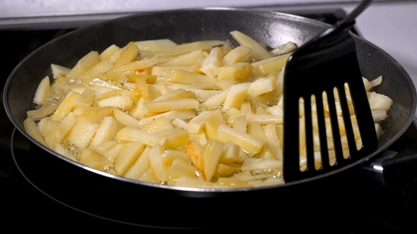 Potatoes Sliced Fried in a Pan
