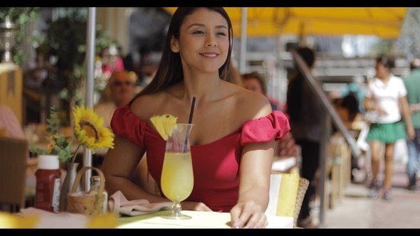 Smiling Woman with Drink in Cafe