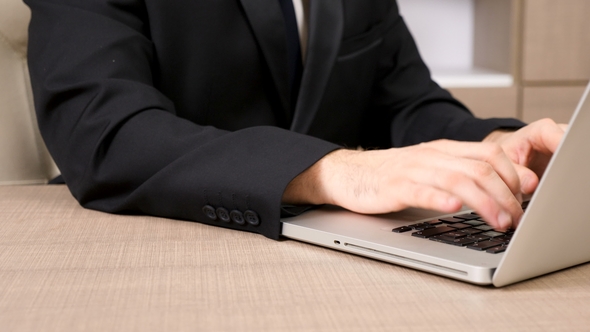 Businessman Hands Typing on Laptop Keyboard