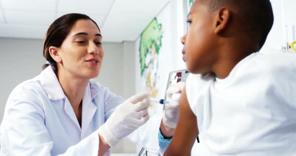 Doctor giving an injection to a boy