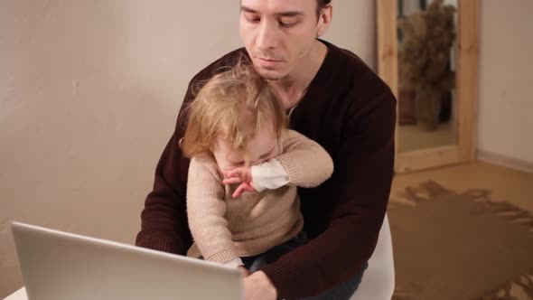 A Man Works at His Laptop at Home