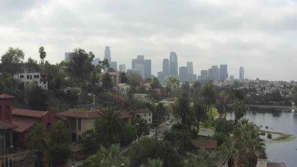 AERIAL: Echo Park Towards Downtown Los Angeles, California with Palm Trees, Cloudy 