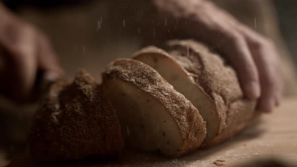 Close Up of Slicing Freshly Baked Bread in the Kitchen