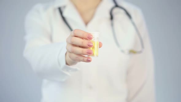 Doctor Holding out Bottle of Pills to Camera, Offering New Drugs, Placebo Effect
