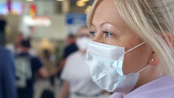 Woman Wearing Medical Protective Mask in Airport Terminal