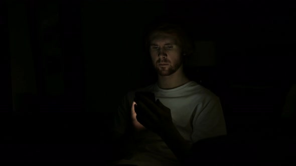 Redhead Man Using Smartphone at Night