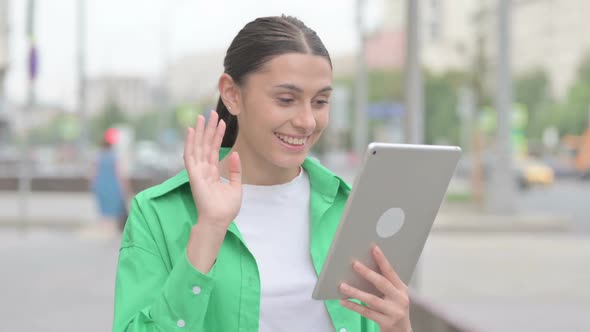 Video Call on Tablet By Hispanic Woman Outdoor