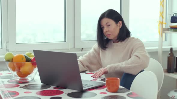 caucasian woman video calling on laptop computer, streaming online webinar training