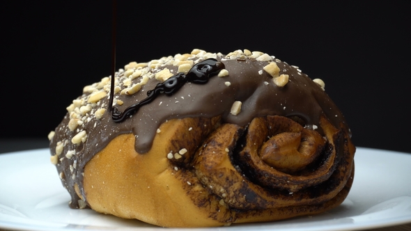 A Chocolate Roll Is Pouring By Hot Melted Cocoa.