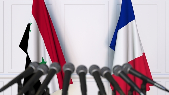 Flags of Syria and France at International Press Conference alt