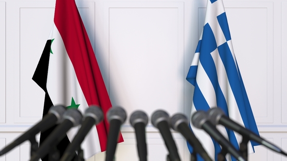Flags of Syria and Greece at International Press Conference alt