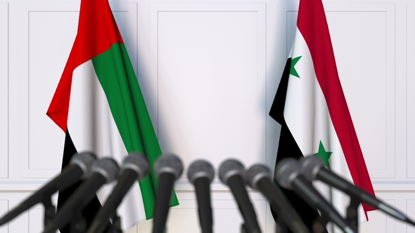 Flags of the UAE and Syria at International Press Conference alt