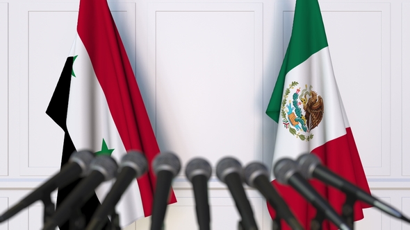 Flags of Syria and Mexico at International Press Conference alt