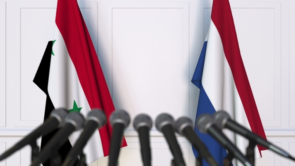 Flags of Syria and Netherlands at International Press Conference alt