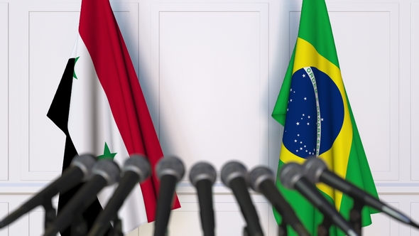 Flags of Syria and Brazil at International Press Conference alt