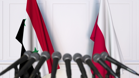 Flags of Syria and Poland at International Press Conference alt