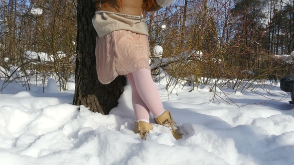 Girl Teenage Eating a Bread and Drinks a Tea on Winter Sunny Day