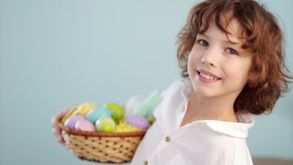 Cute Little Boy with an Easter Basket Smiling Looking at the Camera