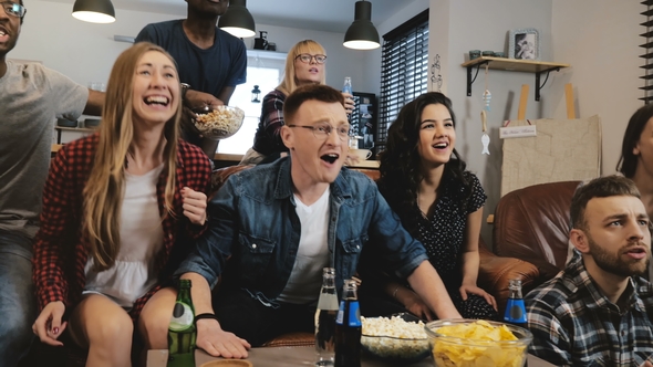 Diverse Football Fans Get Wild Celebrating Win  . Happy Multi Ethnic Friends Watching Sports on T